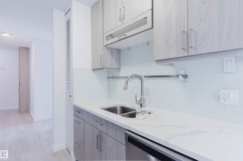Kitchen area featuring light wood-finish cabinetry, white countertop, and white subway tile backsplash - #303 10883 Saskatchewan Dr Nw, Edmonton, AB - Indoor Photo Showing Kitchen With Double Sink With Upgraded Kitchen