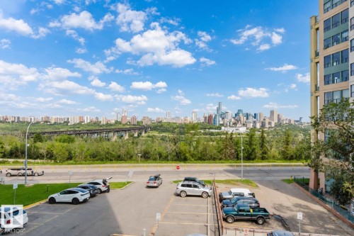 Expansive cityscape backdrop featuring a prominent skyline and lush green landscape - #303 10883 Saskatchewan Dr Nw, Edmonton, AB - Outdoor With View