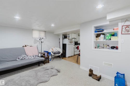 Brightly lit interior space featuring recessed ceiling lights, an integrated wall niche with shelving, and light-colored carpeting - 10955 72 Avenue Nw, Edmonton, AB - Indoor
