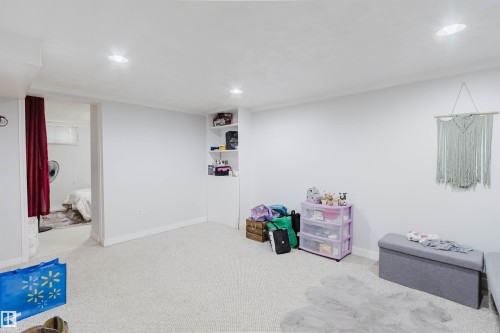 Spacious room with light-colored carpet flooring and recessed ceiling lights - 10955 72 Avenue Nw, Edmonton, AB - Indoor