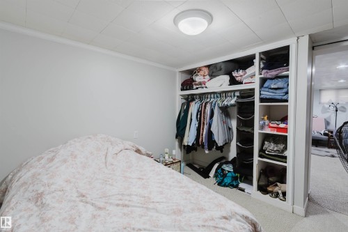 Built-in closet system featuring shelving and hanging space - 10955 72 Avenue Nw, Edmonton, AB - Indoor Photo Showing Bedroom
