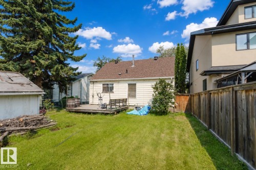 Expansive backyard featuring a green lawn, wood fence, and a detached shed - 10955 72 Avenue Nw, Edmonton, AB - Outdoor