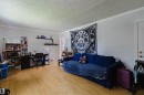 Spacious interior room featuring light wood-finish flooring, white trim, and light-colored walls - 10955 72 Avenue Nw, Edmonton, AB  - Indoor 
