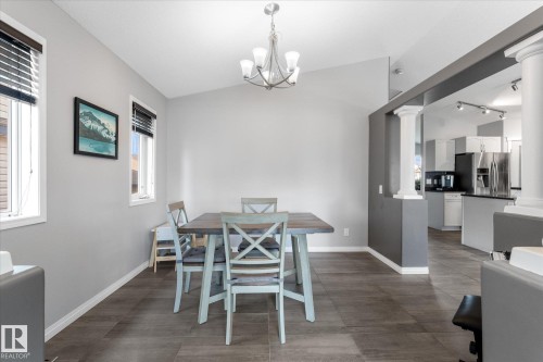 Dining area with vaulted ceiling and wood-finish flooring - 4009 158 Avenue Nw, Edmonton, AB - Indoor Photo Showing Dining Room