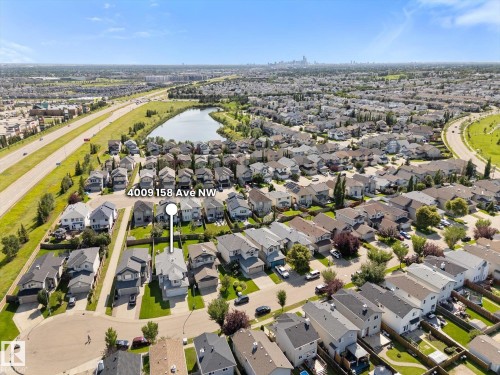 Residential neighborhood featuring a mix of detached homes, a central lake, and multiple thoroughfares - 4009 158 Avenue Nw, Edmonton, AB - Outdoor With View