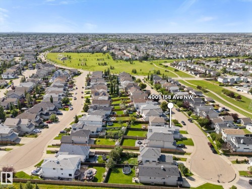 Aerial perspective showcasing a residential neighborhood with detached homes, mature landscaping, and a public green space - 4009 158 Avenue Nw, Edmonton, AB - Outdoor With View