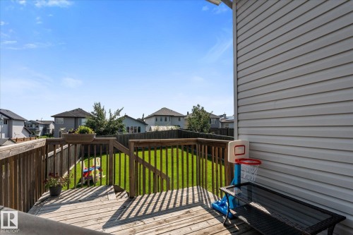 Expansive backyard featuring a wood deck with railings, a privacy fence, and a green lawn - 4009 158 Avenue Nw, Edmonton, AB - Outdoor With Deck Patio Veranda With Exterior