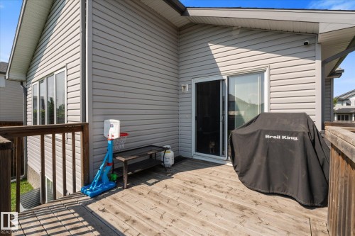 Spacious outdoor deck featuring natural wood-finish planks and a wooden railing - 4009 158 Avenue Nw, Edmonton, AB - Outdoor With Deck Patio Veranda With Exterior