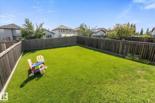Expansive private backyard featuring a manicured lawn, full wood fencing, and clear sky exposure - 4009 158 Avenue Nw, Edmonton, AB - Outdoor With Backyard