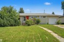 Single-story residence featuring a front yard with mature landscaping and a concrete path - 8215 149 Street Nw, Edmonton, AB  - Outdoor 