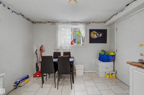 Dining area featuring light-toned tile flooring and a window with natural light - 8215 149 Street Nw, Edmonton, AB - Indoor
