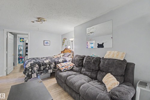Light-toned wood-finish flooring extends throughout this versatile space, complemented by neutral wall paint - 8215 149 Street Nw, Edmonton, AB - Indoor Photo Showing Other Room