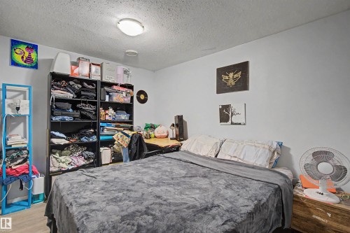 Room with light gray walls and wood-finish flooring - 8215 149 Street Nw, Edmonton, AB - Indoor Photo Showing Bedroom