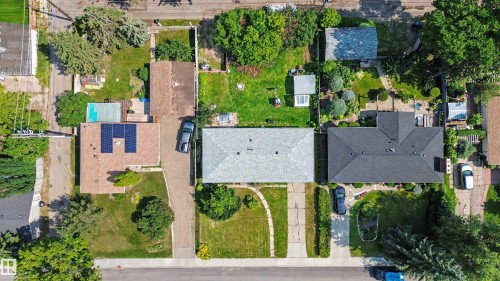 Aerial view highlighting a residential property with a detached garage, a meticulously maintained backyard, and mature landscaping - 8215 149 Street Nw, Edmonton, AB - Outdoor With View