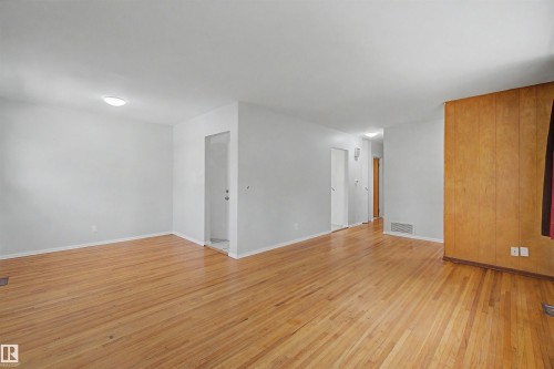 Light wood-finish flooring throughout - 8215 149 Street Nw, Edmonton, AB - Indoor Photo Showing Other Room