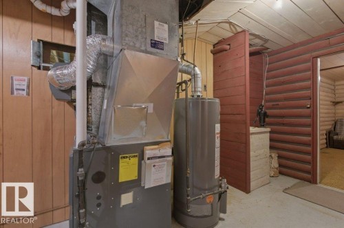 Utility area featuring a water heater and furnace system - 10459 66 Avenue Nw, Edmonton, AB - Indoor Photo Showing Basement