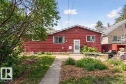 Red exterior siding with white trim around windows and a white entry door - 