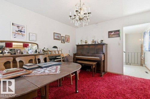 Bright interior space featuring a crystal chandelier and red shag carpeting - 10459 66 Avenue Nw, Edmonton, AB - Indoor