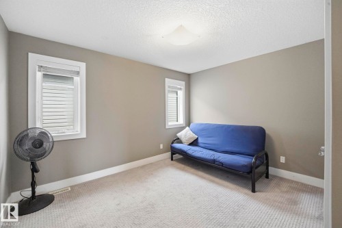 Carpeted room featuring neutral wall tones and white baseboards - 1051 174 Street Sw, Edmonton, AB - Indoor