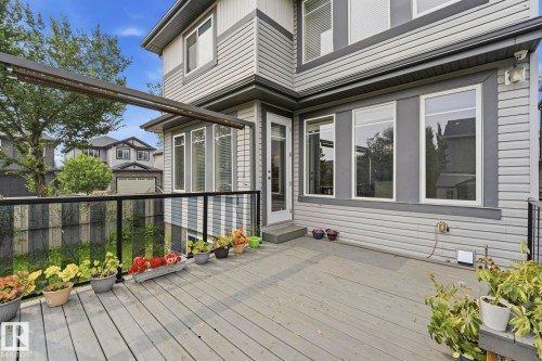 Spacious exterior deck with wood-finish flooring and glass panel railing - 1051 174 Street Sw, Edmonton, AB - Outdoor