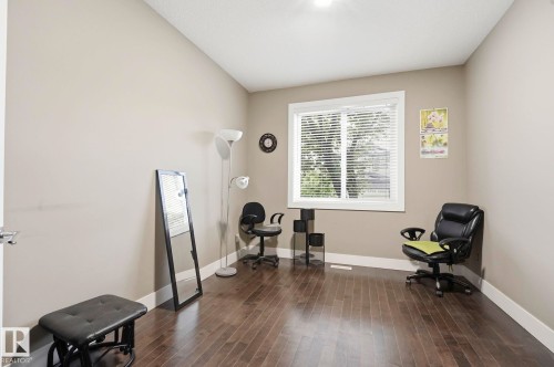 Spacious room featuring wood-finish flooring and neutral wall tones - 1051 174 Street Sw, Edmonton, AB - Indoor