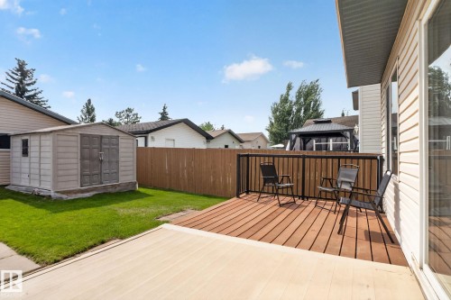 Expansive backyard featuring a combination of wood-finish decking and a concrete patio - 8923 173 Avenue Nw, Edmonton, AB - Outdoor With Exterior