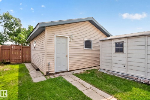 Detached garage with horizontal siding and a single entry door - 8923 173 Avenue Nw, Edmonton, AB - Outdoor With Exterior