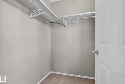 Closet with neutral wall color, carpeted flooring, and white wire shelving - 8923 173 Avenue Nw, Edmonton, AB - Indoor With Storage