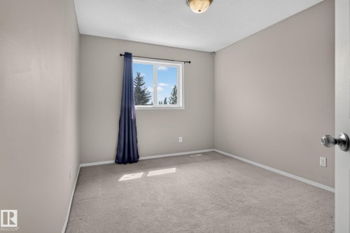 Neutral-toned walls complement the light-colored carpeting - 8923 173 Avenue Nw, Edmonton, AB - Indoor Photo Showing Other Room