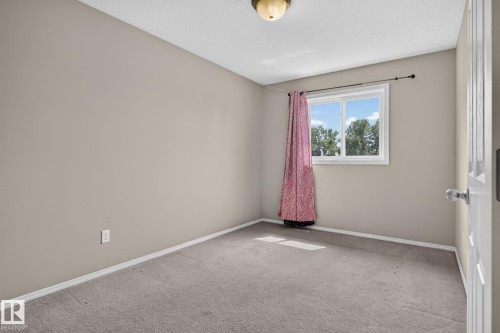 Neutral-toned walls complement the gray carpeting - 8923 173 Avenue Nw, Edmonton, AB - Indoor Photo Showing Other Room