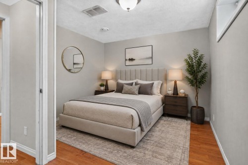 Bedroom featuring wood-finish flooring, light gray wall paint, and a white ceiling - 8923 173 Avenue Nw, Edmonton, AB - Indoor Photo Showing Bedroom