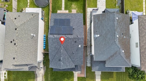 Asphalt shingle roof featuring multiple solar panels - 8923 173 Avenue Nw, Edmonton, AB - Outdoor