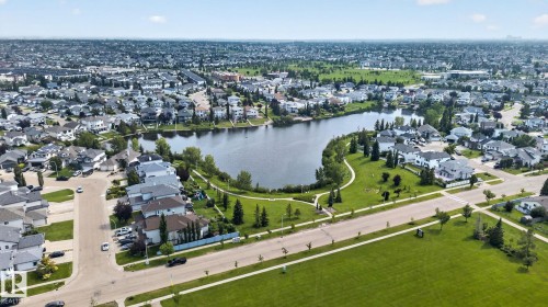 Aerial perspective showcasing a residential area featuring a central lake - 8923 173 Avenue Nw, Edmonton, AB - Outdoor With View