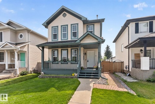 Two-story residence featuring a covered front porch with dark green railings - 8923 173 Avenue Nw, Edmonton, AB - Outdoor With Deck Patio Veranda With Facade