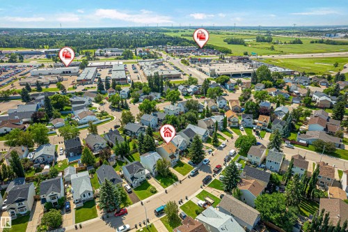 Aerial view of a residential neighborhood with mixed architectural styles, mature landscaping, and commercial properties visible in the background - 281 Vantage Lane, Sherwood Park, AB - Outdoor With View