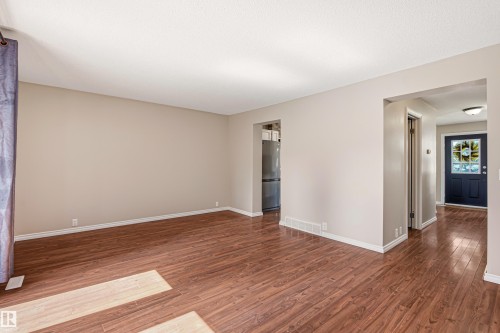 Spacious interior room featuring wood-finish flooring, neutral wall tones, and white trim - 281 Vantage Lane, Sherwood Park, AB - Indoor Photo Showing Other Room