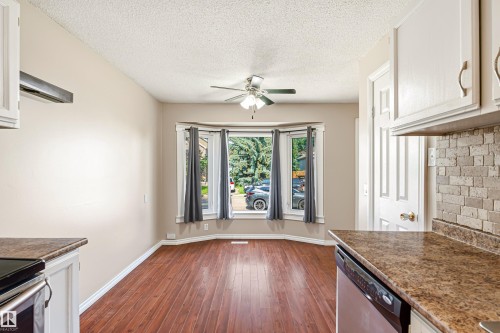 Dining area featuring a bay window, wood-finish flooring, and a ceiling fan - 281 Vantage Lane, Sherwood Park, AB - Indoor Photo Showing Kitchen