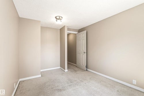 Neutral-toned interior room featuring light beige wall paint, white baseboards, and a textured ceiling - 281 Vantage Lane, Sherwood Park, AB - Indoor Photo Showing Other Room