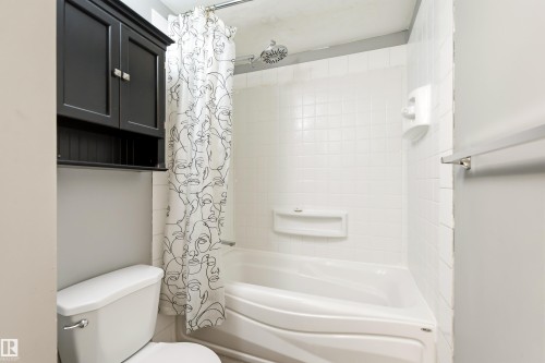 Full bathroom featuring a white tile shower surround, showerhead fixture, and a built-in bathtub - 281 Vantage Lane, Sherwood Park, AB - Indoor Photo Showing Bathroom
