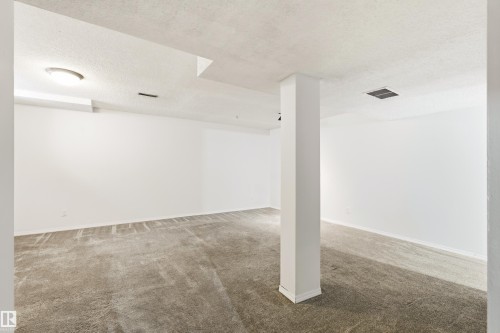 Spacious room with white painted walls, textured ceiling, and gray carpeting - 281 Vantage Lane, Sherwood Park, AB - Indoor
