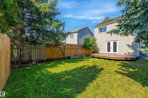 Expansive backyard featuring a manicured lawn, full perimeter wood fencing, and mature trees - 281 Vantage Lane, Sherwood Park, AB - Outdoor