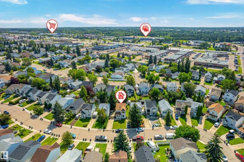 Aerial perspective highlighting a residential neighborhood with detached homes, mature trees, and commercial establishments in the background - 281 Vantage Lane, Sherwood Park, AB - Outdoor With View