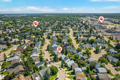 Expansive aerial perspective showcasing a residential neighborhood with a meandering waterway and mature tree coverage - 281 Vantage Lane, Sherwood Park, AB - Outdoor With View