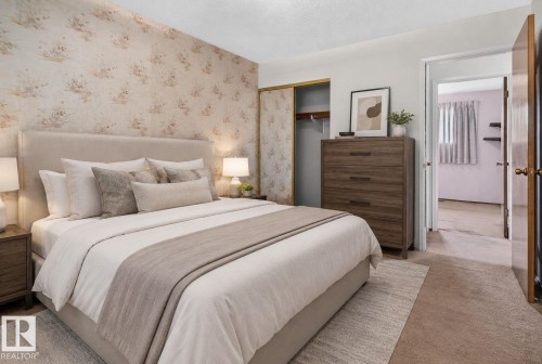 Bedroom featuring a floral accent wall, neutral carpeting, and a built-in closet with sliding doors - 6012 145 Avenue Nw, Edmonton, AB - Indoor Photo Showing Bedroom