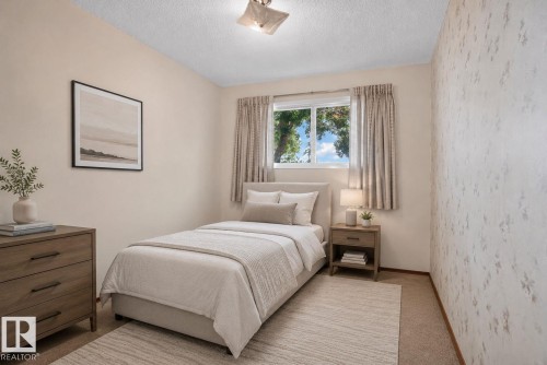 Bedroom featuring a single window with natural light, textured wallpaper, and carpeting - 6012 145 Avenue Nw, Edmonton, AB - Indoor Photo Showing Bedroom