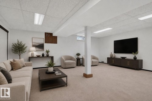 Spacious recreational area featuring neutral wall tones, recessed window, and light-toned carpeting - 6012 145 Avenue Nw, Edmonton, AB - Indoor
