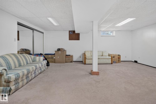 Spacious finished lower level featuring wall-to-wall carpeting, recessed lighting, and a drop ceiling - 6012 145 Avenue Nw, Edmonton, AB - Indoor Photo Showing Basement