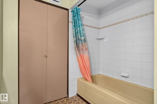 Bathtub with white subway tile surround and decorative accent border - 6012 145 Avenue Nw, Edmonton, AB - Indoor Photo Showing Bathroom
