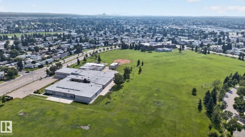 Expansive green space and a large educational facility, surrounded by residential areas - 6012 145 Avenue Nw, Edmonton, AB - Outdoor With View