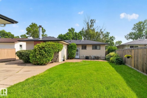 Expansive rear yard featuring a manicured lawn, established landscaping, and a privacy fence - 6012 145 Avenue Nw, Edmonton, AB - Outdoor